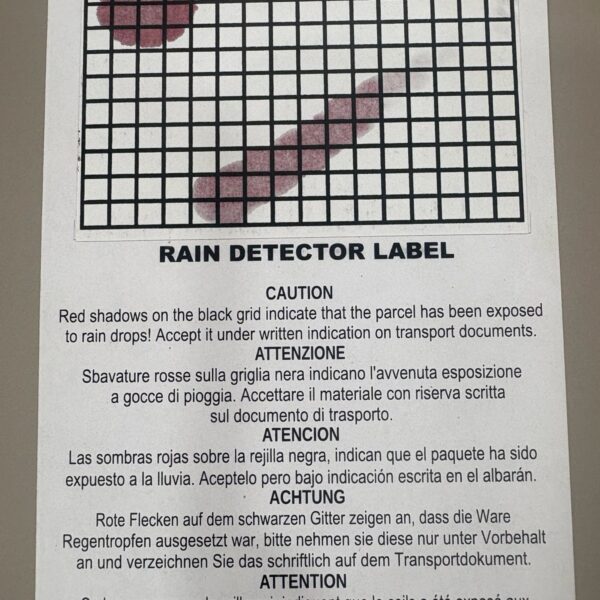 Activated rain detector label showing red shadows on the grid after water exposure